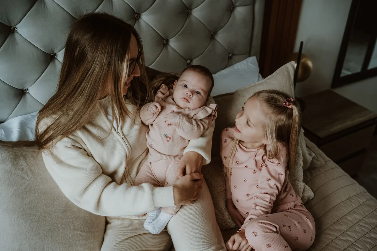 A baby held close by a parent