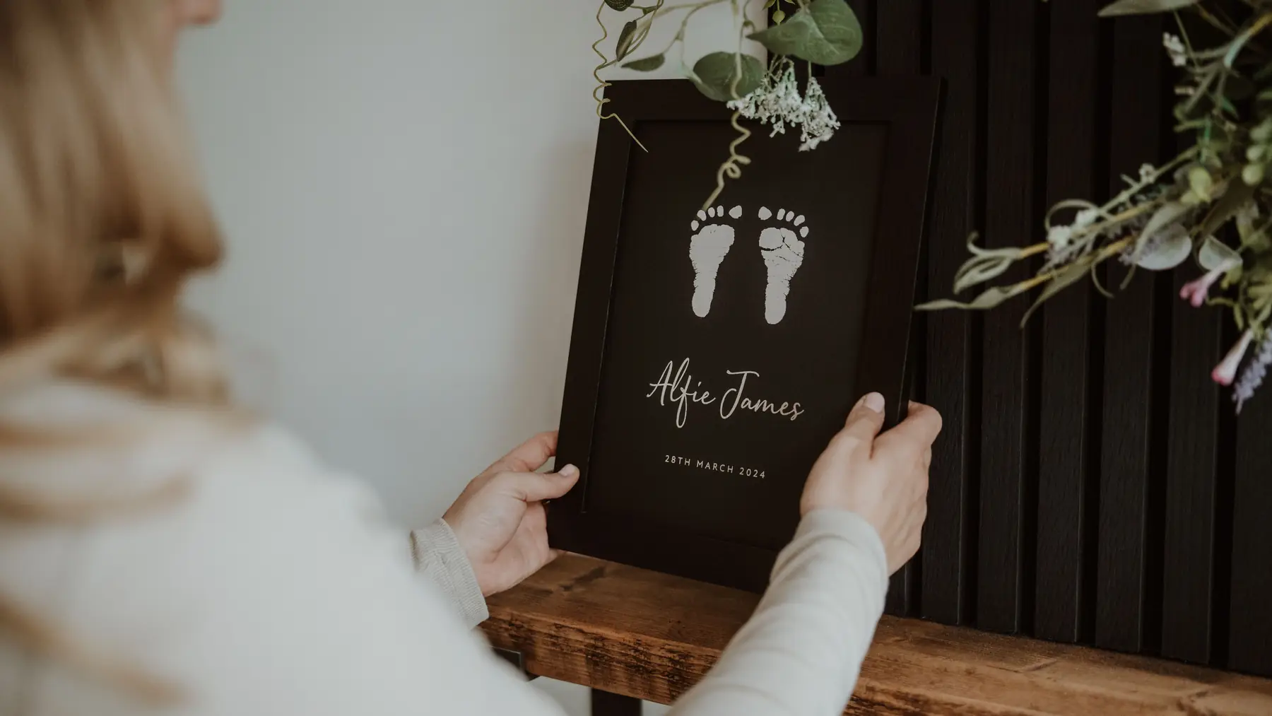 A framed foil keepsake on a shelf