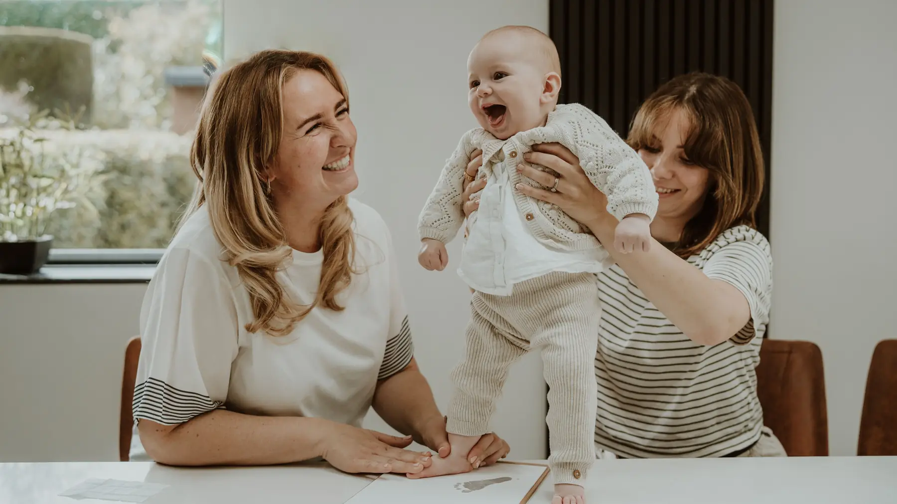 A family taking their baby's prints together
