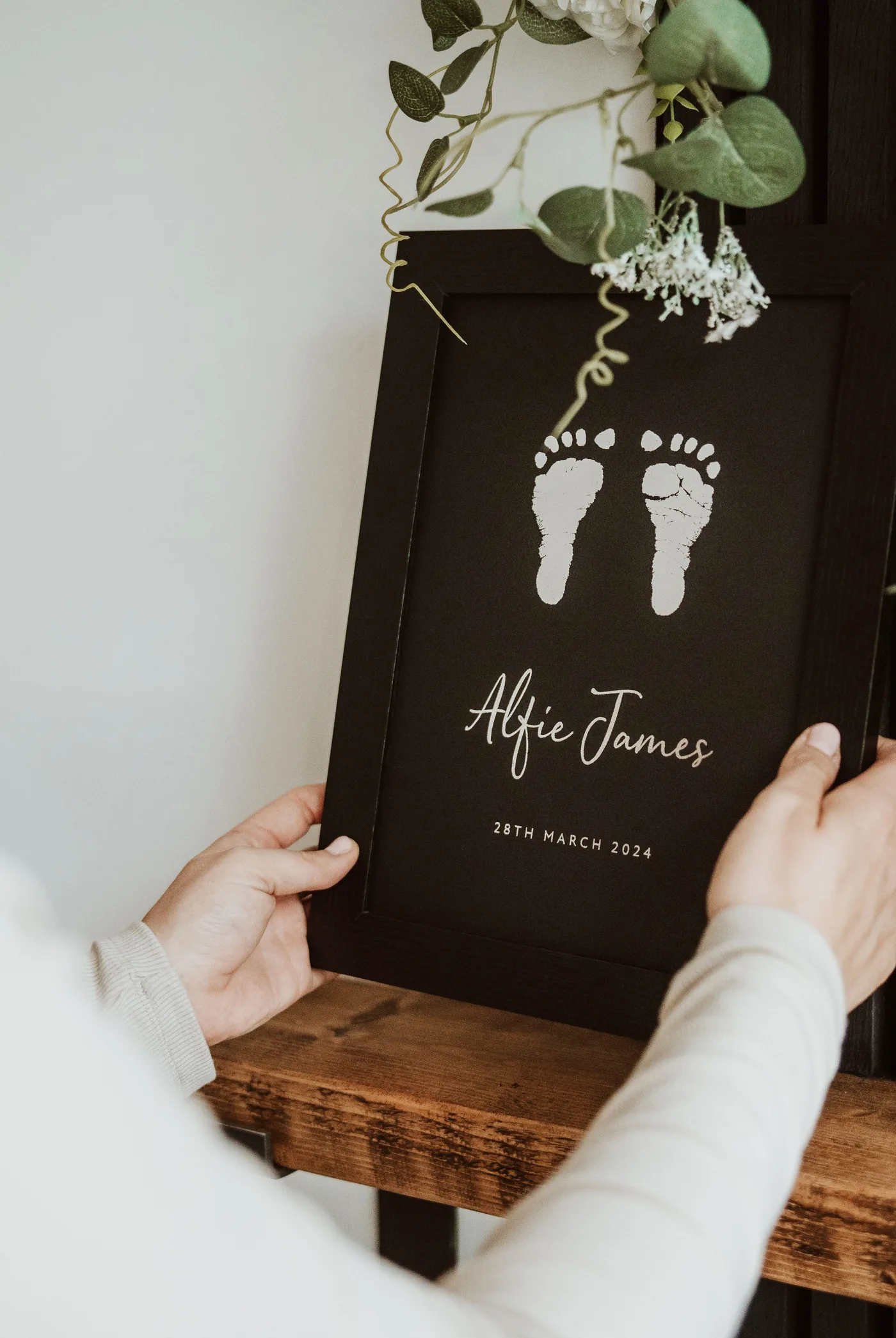 A framed keepsake styled on a shelf