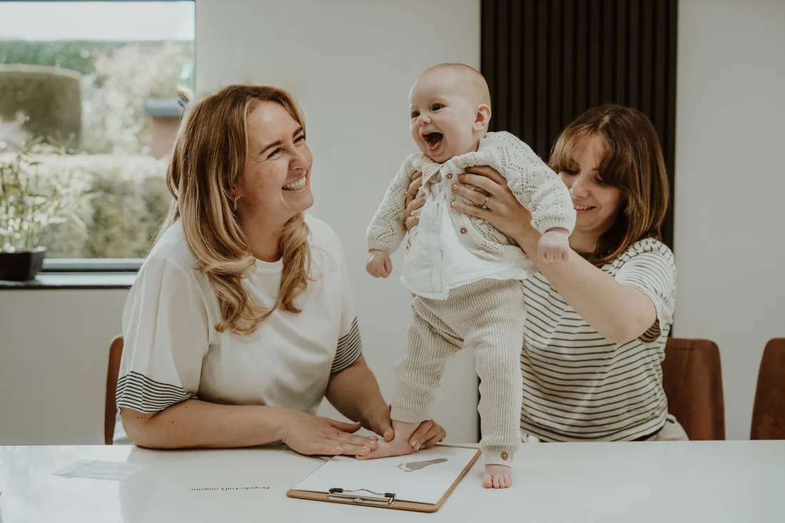 A family taking their baby's prints