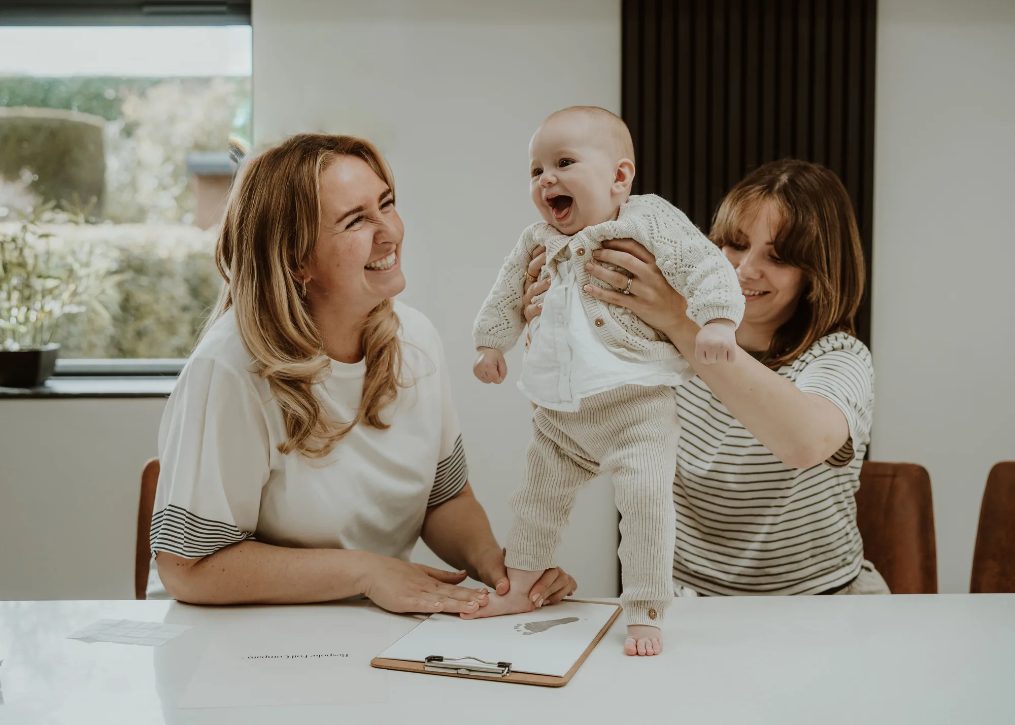A family taking their baby's prints
