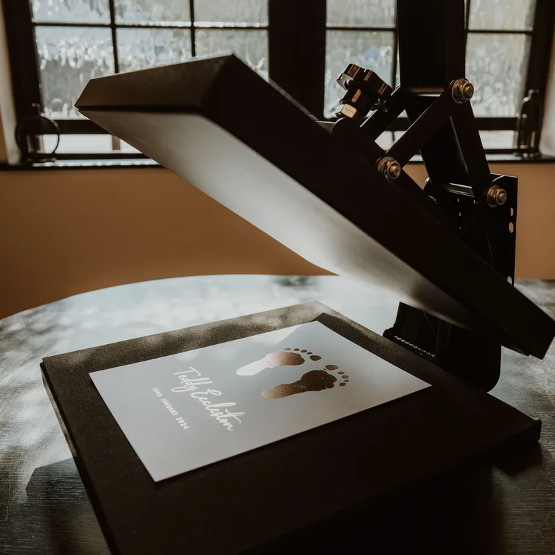 A foil print being hand-pressed on the heat press in our workshop