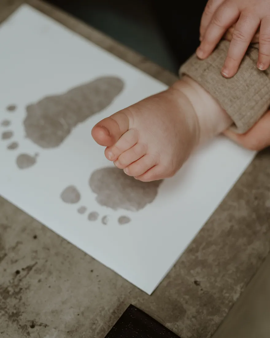 Pressing a baby's hand onto the reactive paper
